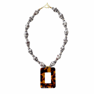 A brown Chinoiserie necklace made with ginger jar shaped porcelain beads and a tortoise shell pendant 